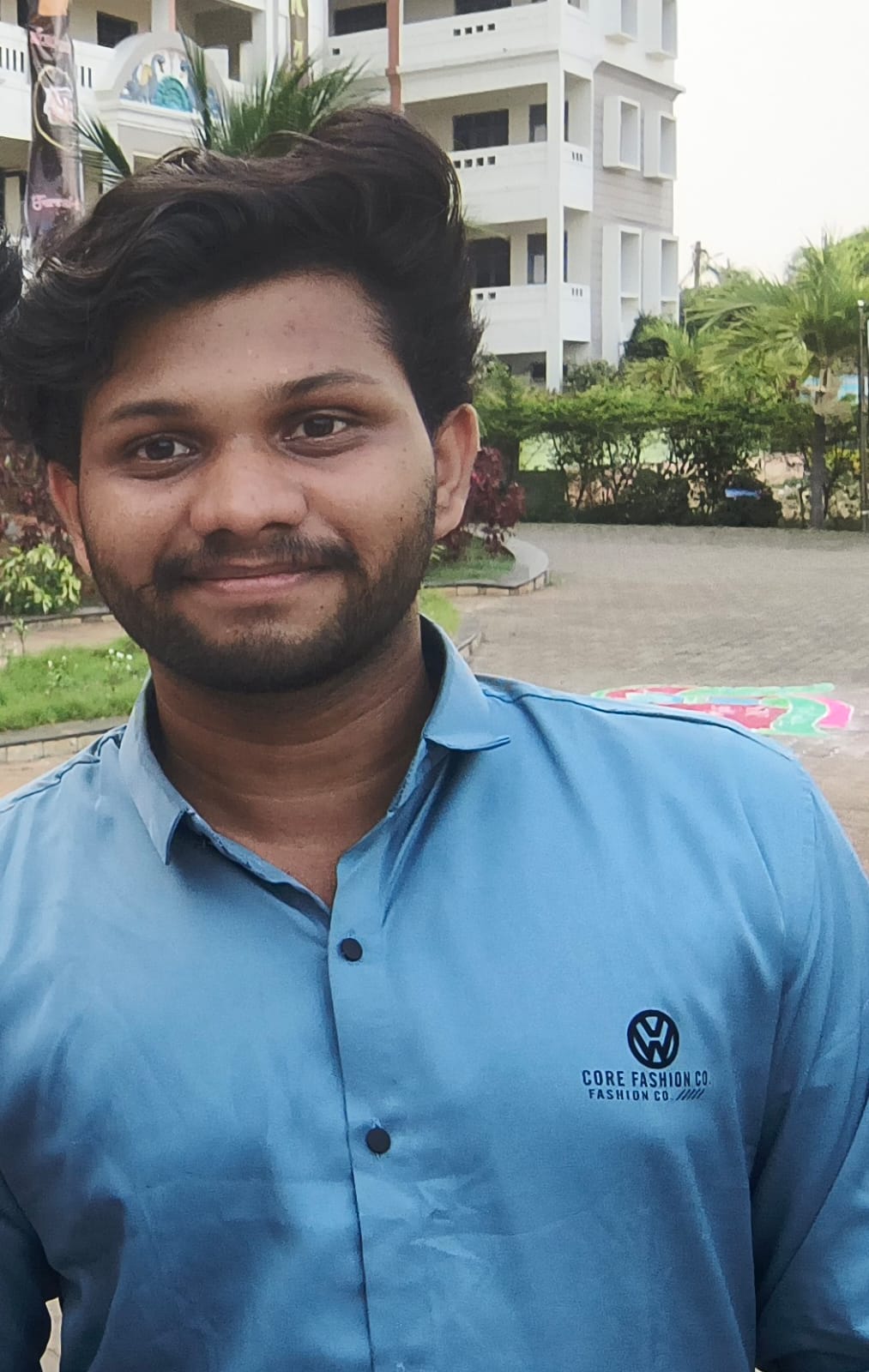 Medisetti Renukeswar in a professional setting, wearing a suit and tie